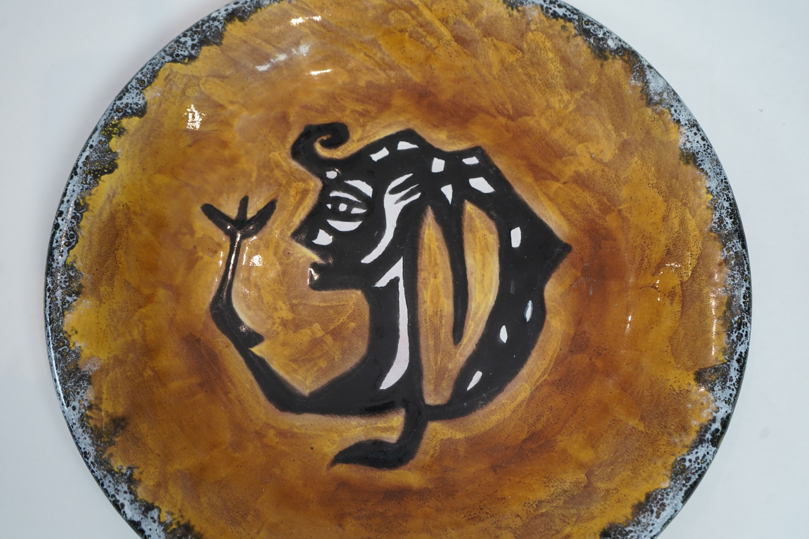 Jean Lurçat (1892-1966): An ochre glazed earthenware plate, decorated with a stylised central figure